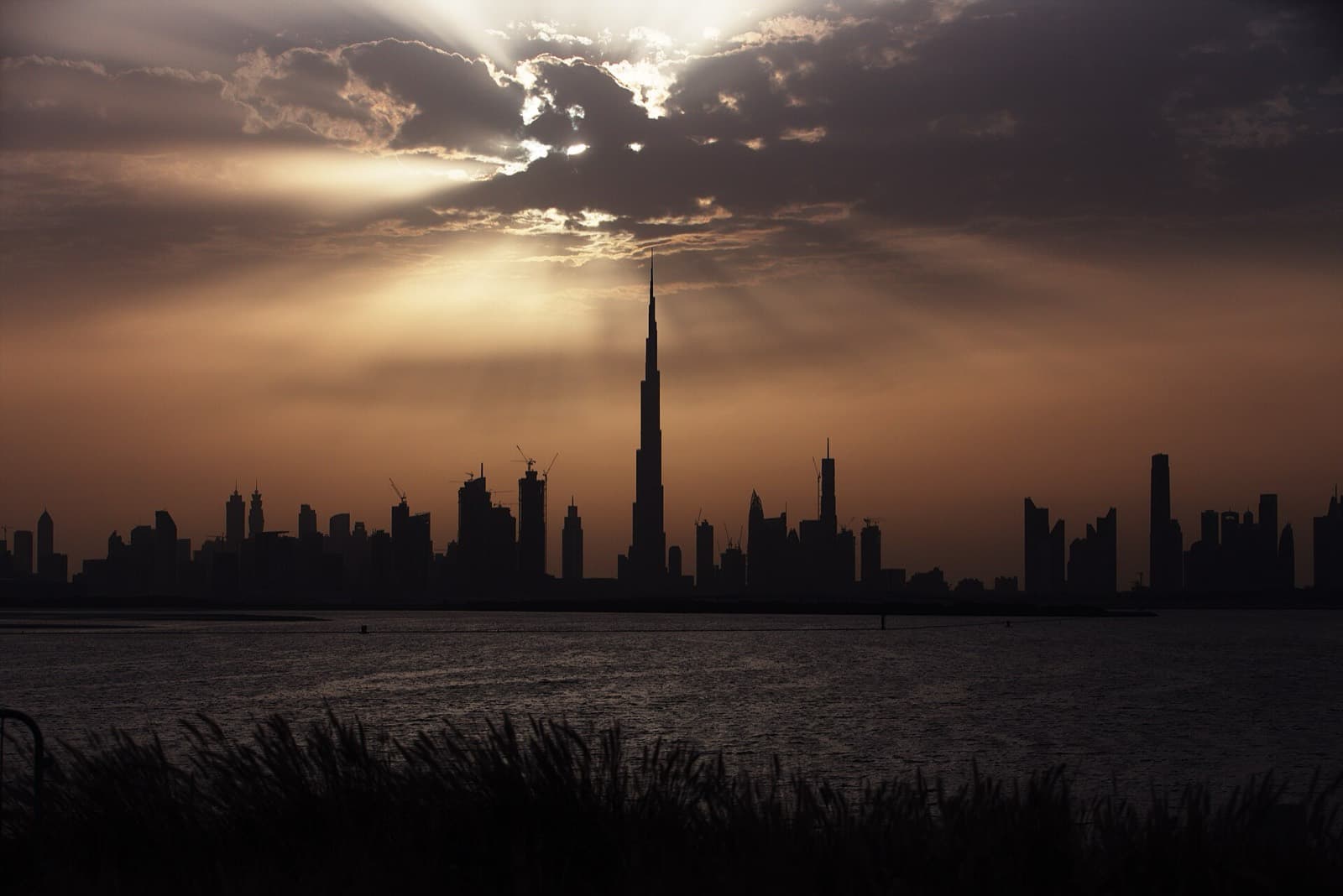 The Burj Khalifa and Dubai skyline silhouetted at sunset, UAE