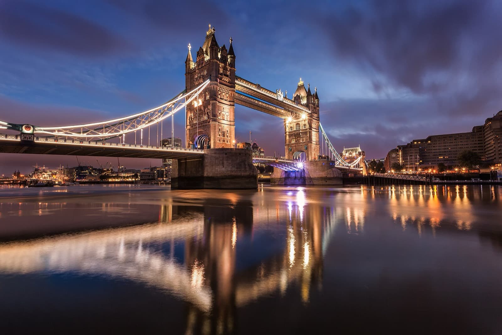 Tower Bridge lit at dawn over the Thames, London, UK